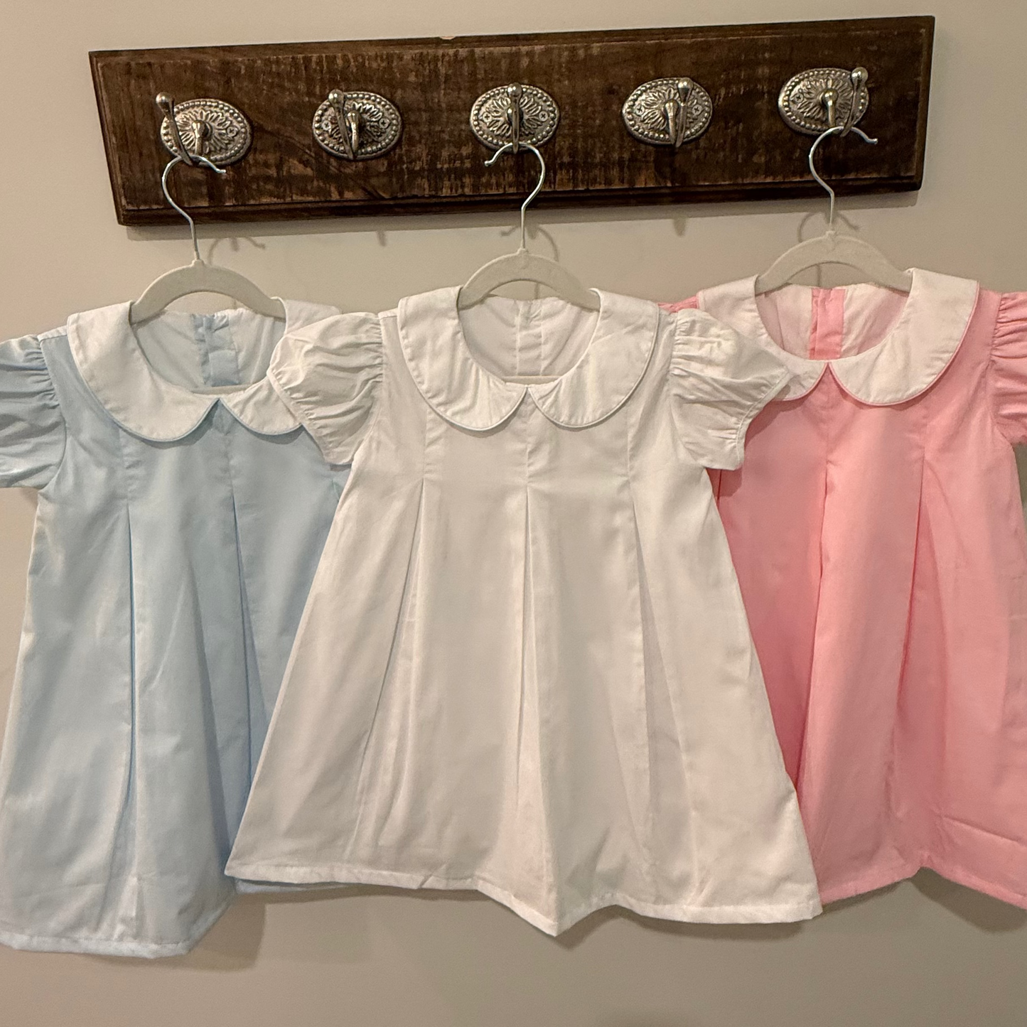 three double-lined cotton dress. one blue, one white and one pink with peter pan collars